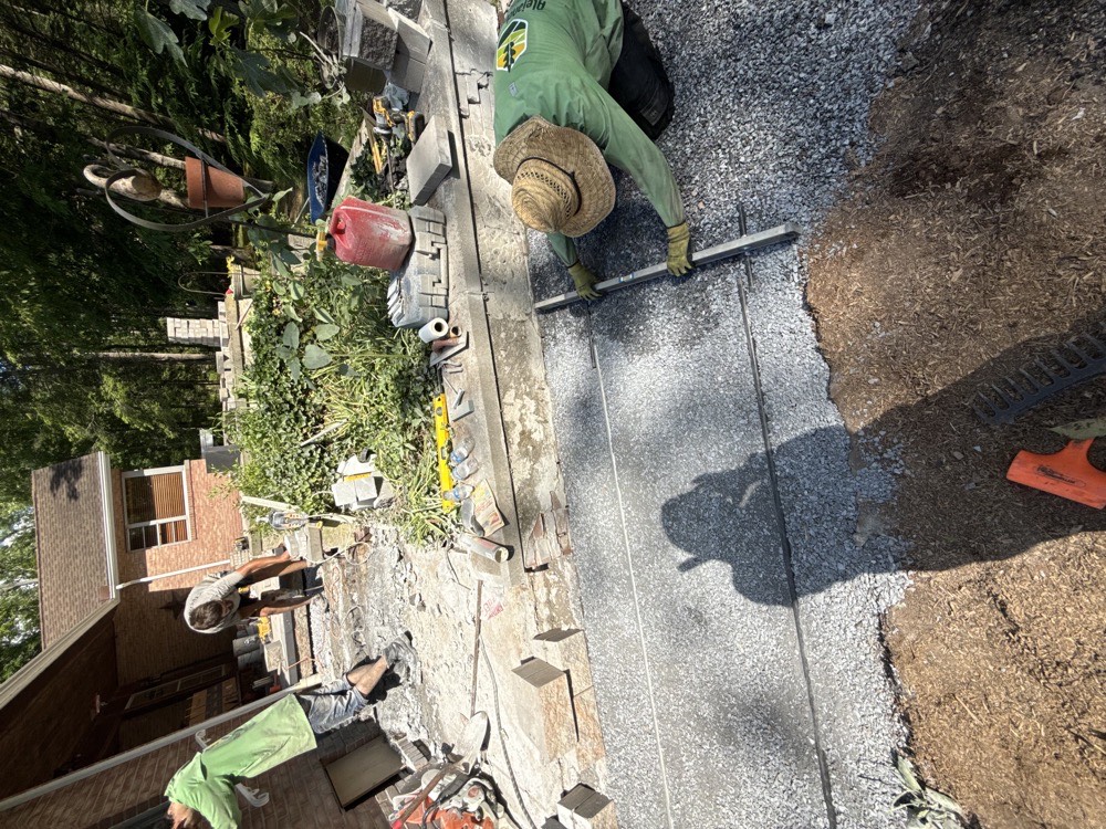Alejandros Landscaping crew installing paver base